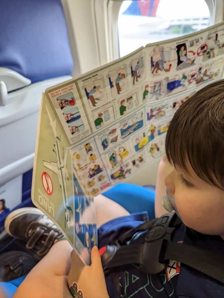 Safety manuals can make for entertaining toddler reading on an airplane. 